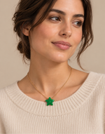 Woman wearing a green Tagua star pendant necklace on a fine gold-tone chain