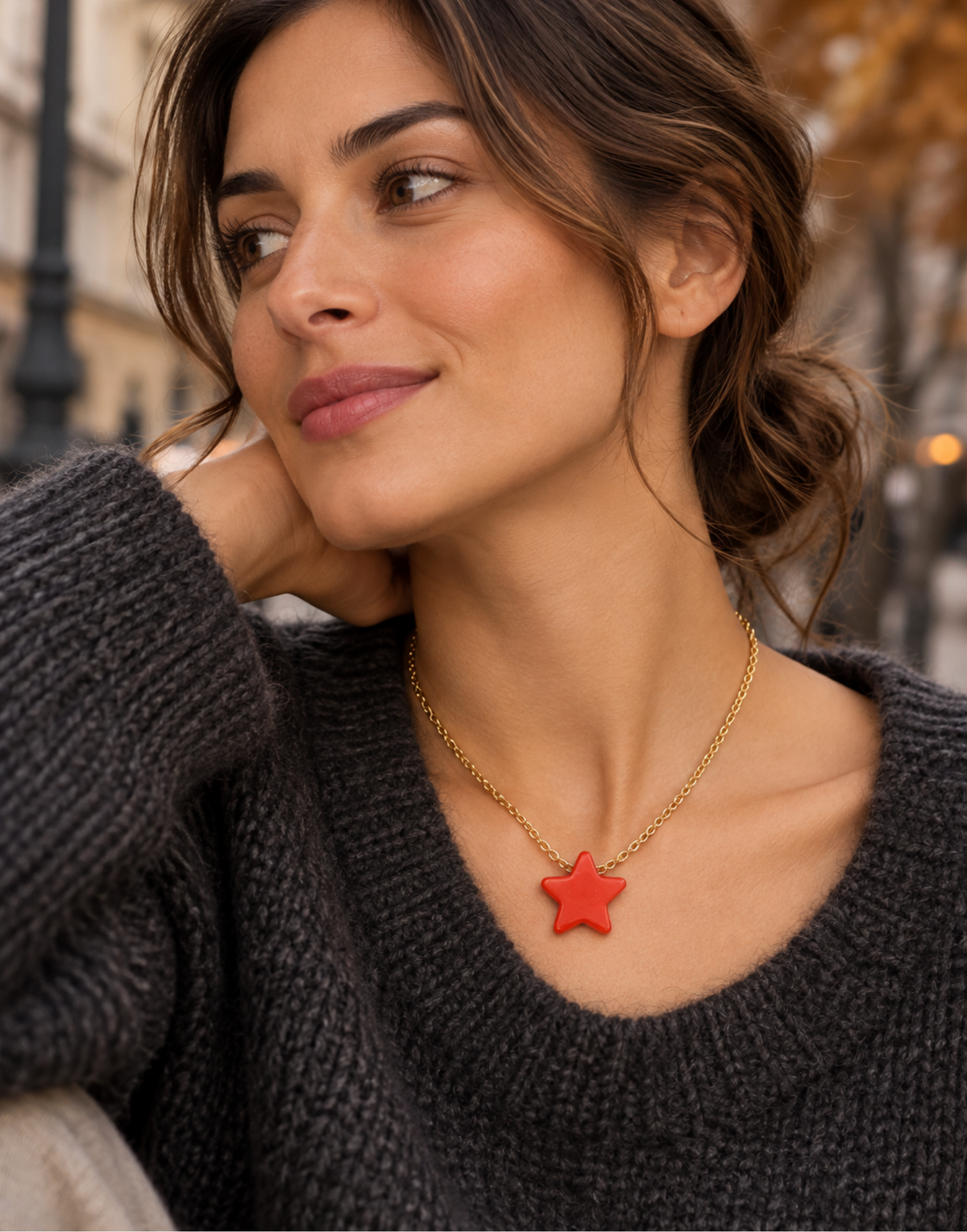 Woman wearing ar ed Tagua star pendant necklace on a fine gold-tone chain